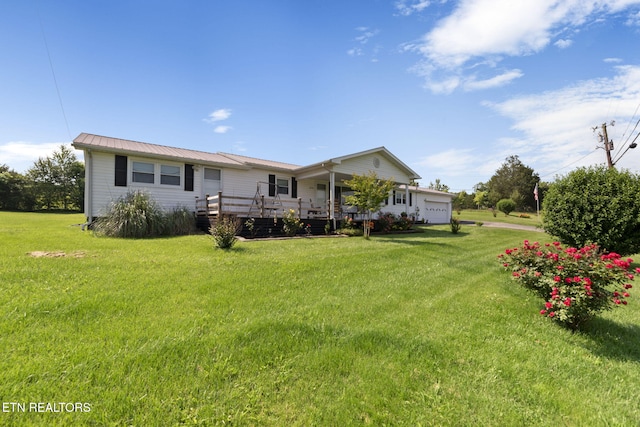 8318 Clapps Chapel Rd, Corryton, TN 37721 - rear view of house featuring an attached garage, a lawn, and metal roof