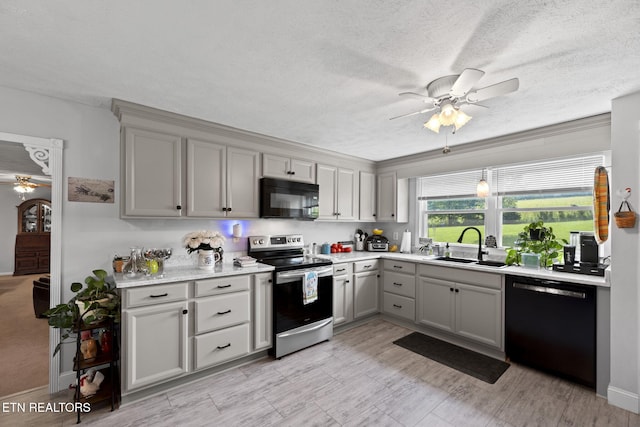 8318 Clapps Chapel Rd, Corryton, TN 37721 - kitchen featuring black appliances, a ceiling fan, gray cabinets, a sink, and light countertops
