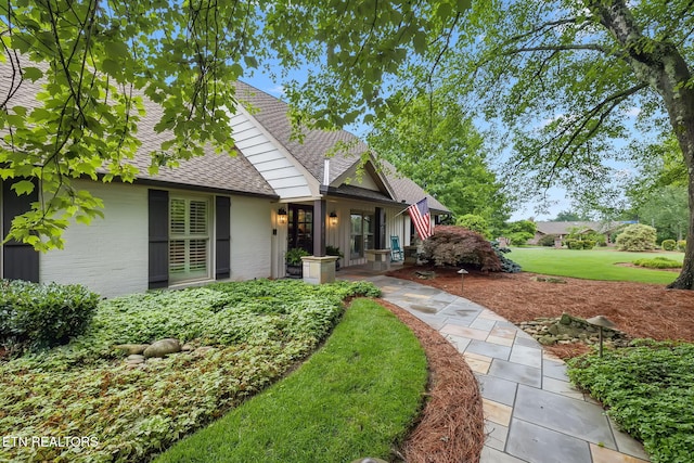 12368 N Fox Den Dr, Knoxville, TN 37934 - view of front of house with a shingled roof, brick siding, and a front lawn