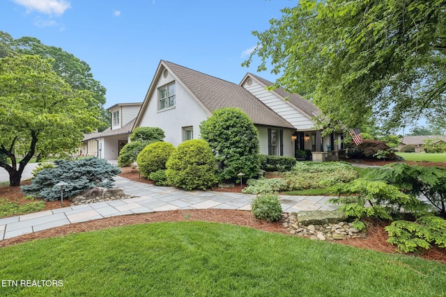 12368 N Fox Den Dr, Knoxville, TN 37934 - view of front of property with a front yard, a shingled roof, and stucco siding