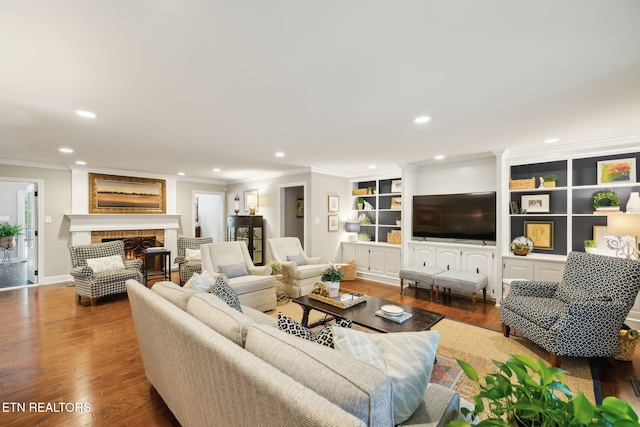 12368 N Fox Den Dr, Knoxville, TN 37934 - living area with crown molding, recessed lighting, wood finished floors, a fireplace, and built in shelves