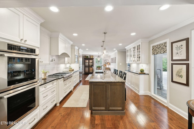 12368 N Fox Den Dr, Knoxville, TN 37934 - kitchen with a sink, ornamental molding, backsplash, glass insert cabinets, and stainless steel appliances