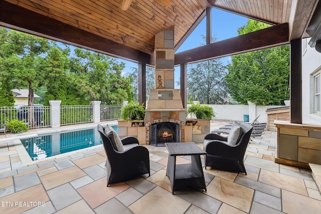 12368 N Fox Den Dr, Knoxville, TN 37934 - fenced backyard featuring a lit fireplace and a patio