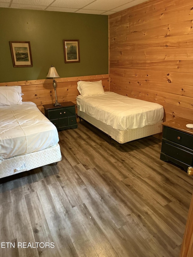 2020 Regans Ridge Way, Sevierville, TN 37876 - bedroom featuring a drop ceiling, wood walls, and wood finished floors