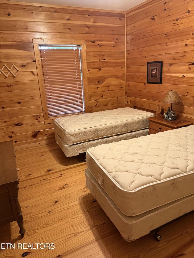 2020 Regans Ridge Way, Sevierville, TN 37876 - bedroom featuring wooden walls and light wood-style floors
