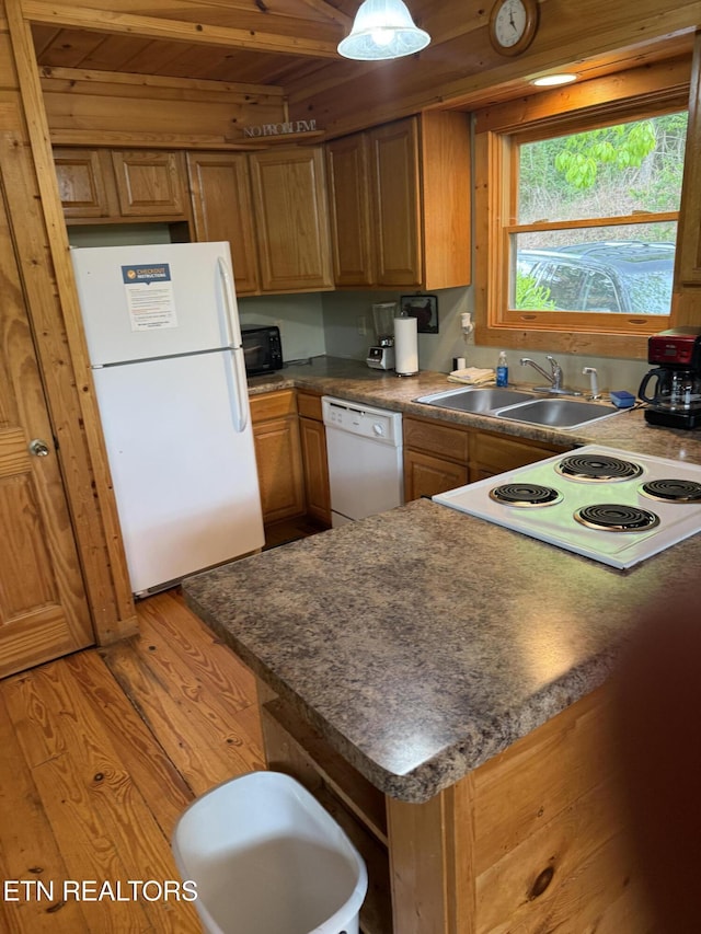 2020 Regans Ridge Way, Sevierville, TN 37876 - kitchen featuring white appliances, light wood-type flooring, dark countertops, brown cabinetry, and wood ceiling