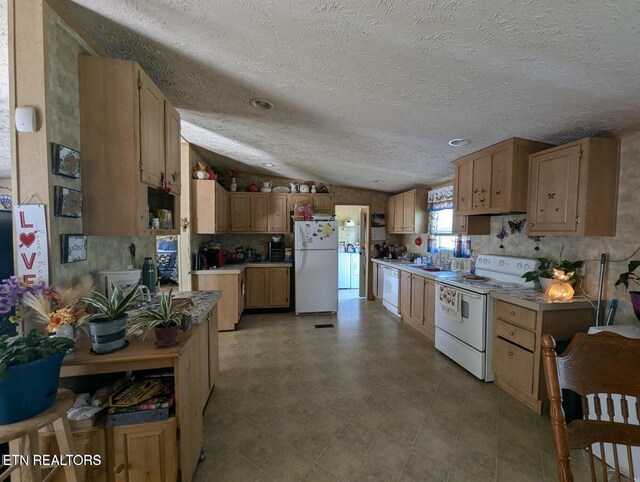 626 S 22nd St, Middlesboro, KY 40965 - kitchen with white appliances, light countertops, a textured ceiling, and lofted ceiling