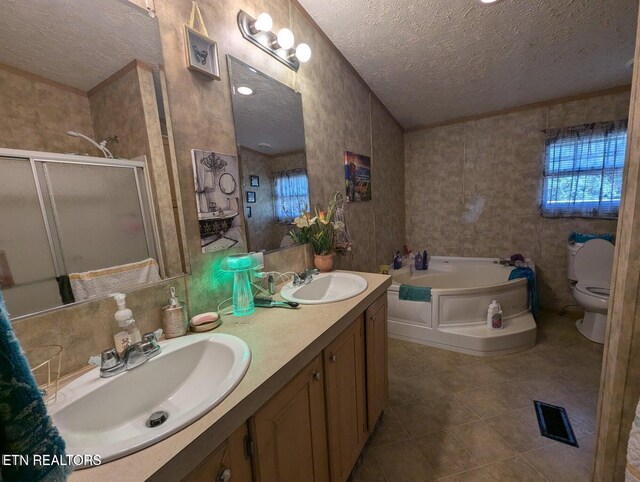 626 S 22nd St, Middlesboro, KY 40965 - bathroom with a textured ceiling, a bath, tile patterned floors, a shower stall, and double vanity