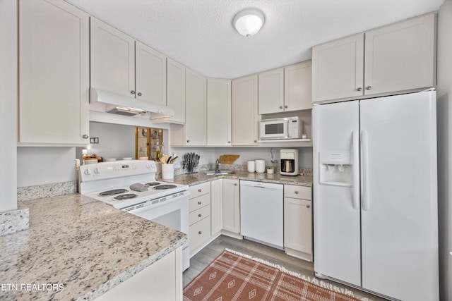 613 Vose Rd Unit B, Alcoa, TN 37701 - kitchen featuring white appliances, under cabinet range hood, a textured ceiling, and light stone countertops
