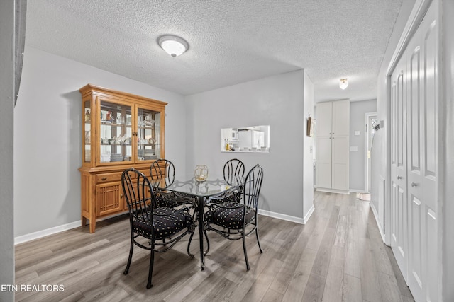 613 Vose Rd Unit B, Alcoa, TN 37701 - dining room with light wood-style flooring, baseboards, and a textured ceiling
