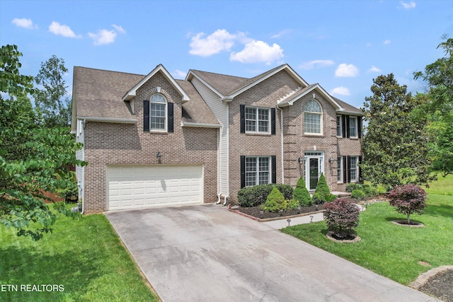 7127 Fieldstone Farms Ln, Knoxville, TN 37921 - view of front of home featuring driveway, a front lawn, brick siding, an attached garage, and a shingled roof