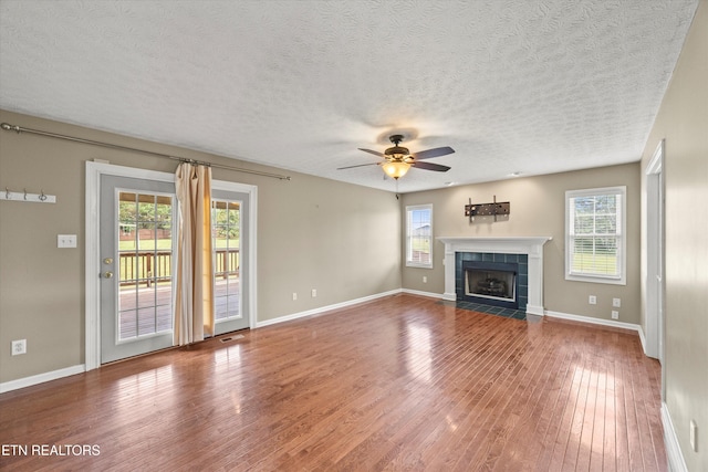 7127 Fieldstone Farms Ln, Knoxville, TN 37921 - unfurnished living room with a ceiling fan, plenty of natural light, wood finished floors, and a textured ceiling
