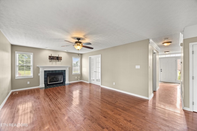 7127 Fieldstone Farms Ln, Knoxville, TN 37921 - unfurnished living room featuring ceiling fan, wood finished floors, healthy amount of natural light, baseboards, and a textured ceiling