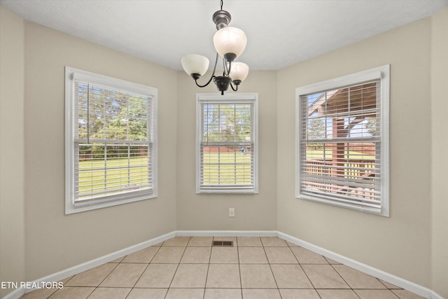 7127 Fieldstone Farms Ln, Knoxville, TN 37921 - unfurnished dining area featuring a chandelier, baseboards, and light tile patterned floors