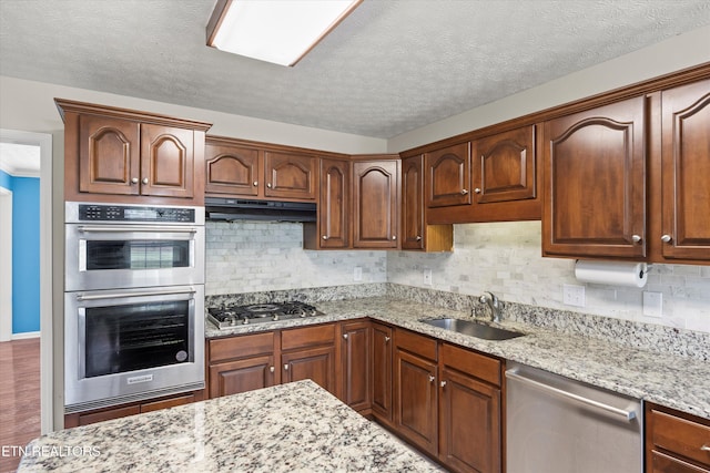 7127 Fieldstone Farms Ln, Knoxville, TN 37921 - kitchen with stainless steel appliances, a sink, light stone counters, backsplash, and a textured ceiling