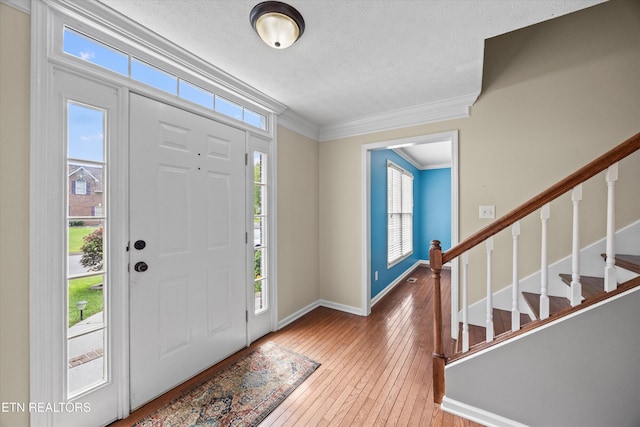7127 Fieldstone Farms Ln, Knoxville, TN 37921 - entryway featuring hardwood / wood-style flooring, stairway, a textured ceiling, baseboards, and crown molding