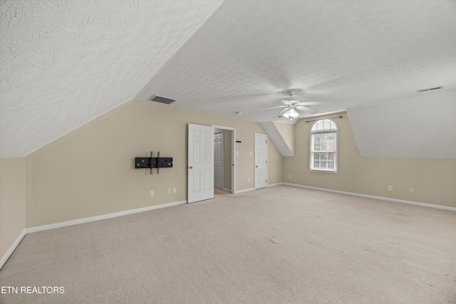 7127 Fieldstone Farms Ln, Knoxville, TN 37921 - bonus room featuring a textured ceiling, vaulted ceiling, ceiling fan, light colored carpet, and baseboards