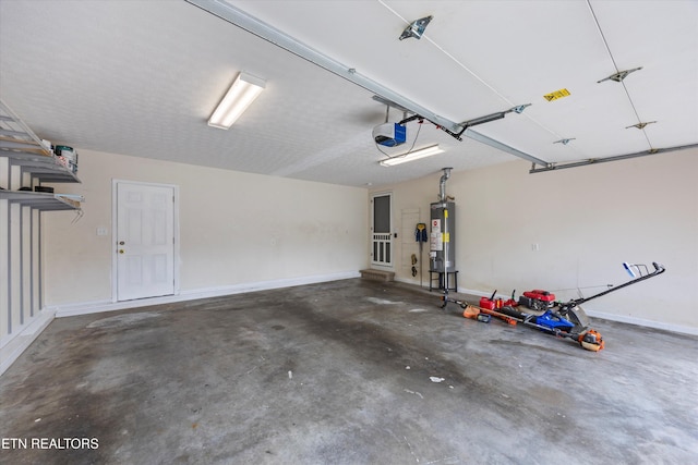 7127 Fieldstone Farms Ln, Knoxville, TN 37921 - garage with gas water heater, a garage door opener, and baseboards