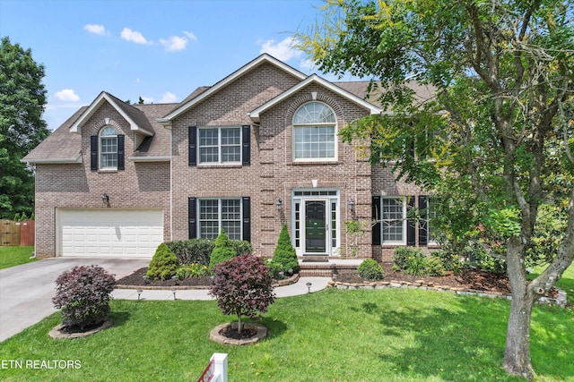 7127 Fieldstone Farms Ln, Knoxville, TN 37921 - colonial inspired home featuring concrete driveway, brick siding, a shingled roof, and a garage