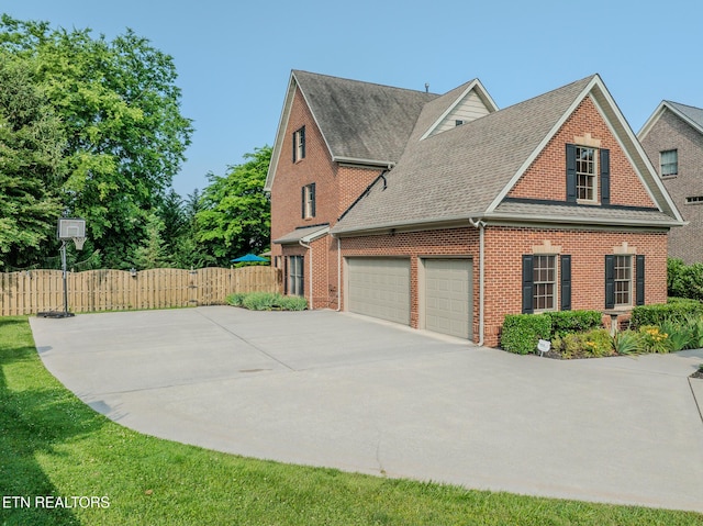 1201 Bentley Park Ln, Knoxville, TN 37922 - view of home's exterior with concrete driveway, brick siding, a shingled roof, and an attached garage
