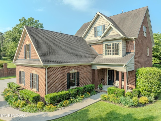 1201 Bentley Park Ln, Knoxville, TN 37922 - view of front of property featuring brick siding, covered porch, a shingled roof, and a front yard