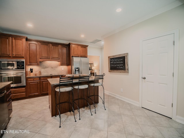1201 Bentley Park Ln, Knoxville, TN 37922 - kitchen with appliances with stainless steel finishes, a kitchen bar, backsplash, crown molding, and baseboards