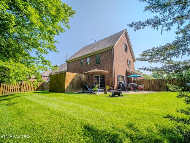 1201 Bentley Park Ln, Knoxville, TN 37922 - rear view of house with a patio, brick siding, and a fire pit
