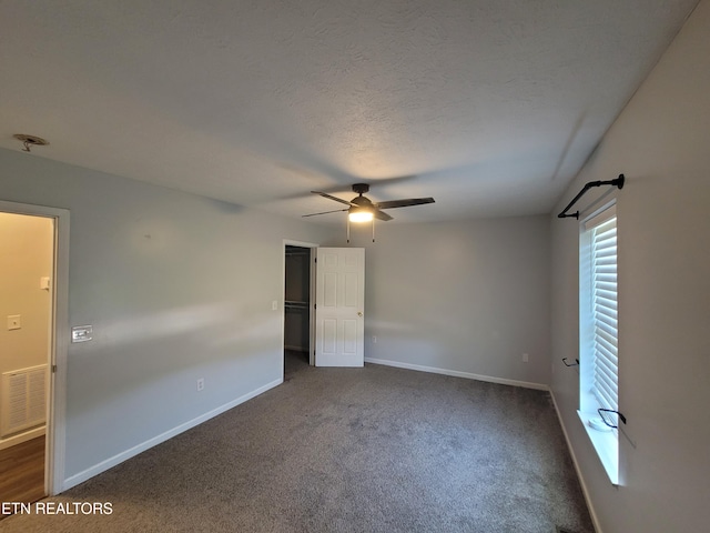 4121 Briggs Loop, Kodak, TN 37764 - unfurnished bedroom with dark colored carpet, baseboards, a ceiling fan, a closet, and a textured ceiling