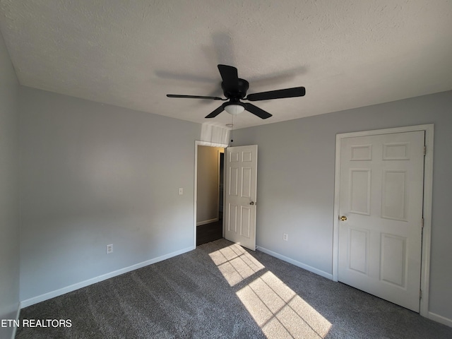 4121 Briggs Loop, Kodak, TN 37764 - unfurnished bedroom featuring dark colored carpet, a textured ceiling, baseboards, and a ceiling fan