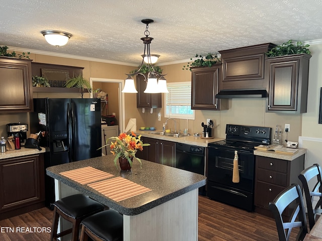 3385 Double Top Rd, Byrdstown, TN 38549 - kitchen with black appliances, independent washer and dryer, dark brown cabinets, exhaust hood, and dark wood-style floors