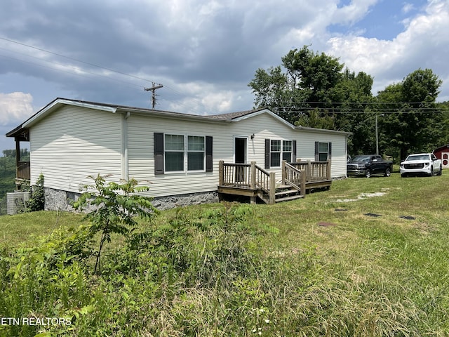 3385 Double Top Rd, Byrdstown, TN 38549 - back of property featuring a yard, a wooden deck, and central AC unit