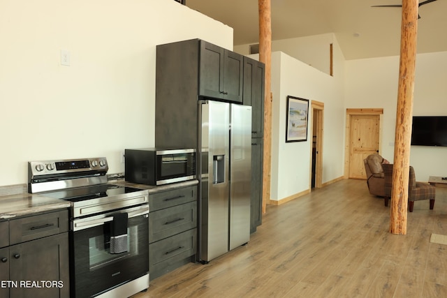840 Ali Ln, Pvt, Huntsville, TN 37756 - kitchen with appliances with stainless steel finishes, light wood-style flooring, high vaulted ceiling, light countertops, and baseboards