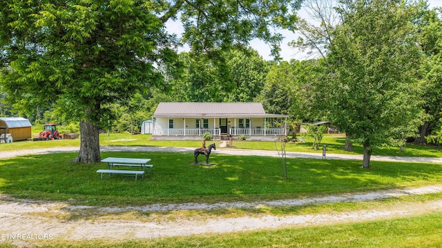 168 Boatman Rd, Cookeville, TN 38506 - view of front of home featuring a porch, a front lawn, metal roof, and curved driveway