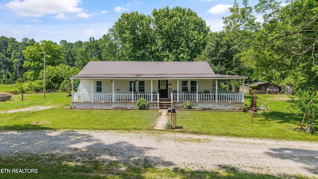 168 Boatman Rd, Cookeville, TN 38506 - farmhouse inspired home with covered porch, a view of trees, a front yard, and metal roof
