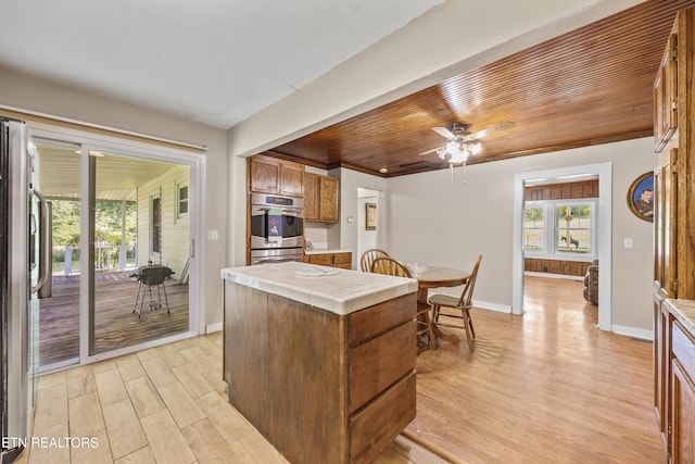 168 Boatman Rd, Cookeville, TN 38506 - kitchen with tile countertops, stainless steel appliances, light wood finished floors, brown cabinets, and wooden ceiling