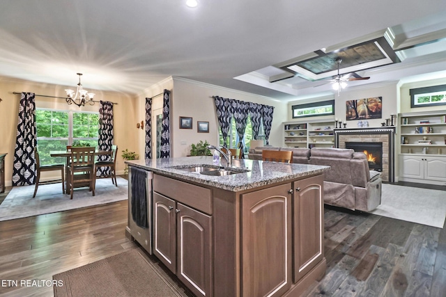 247 Thrushwood Dr, Fairfield Glade, TN 38558 - kitchen with a sink, a chandelier, crown molding, dark wood-type flooring, and a lit fireplace