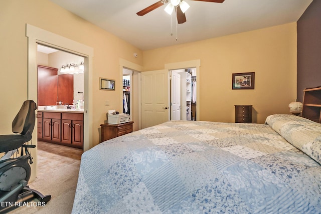 247 Thrushwood Dr, Fairfield Glade, TN 38558 - bedroom with light colored carpet, ensuite bathroom, a walk in closet, a ceiling fan, and a closet