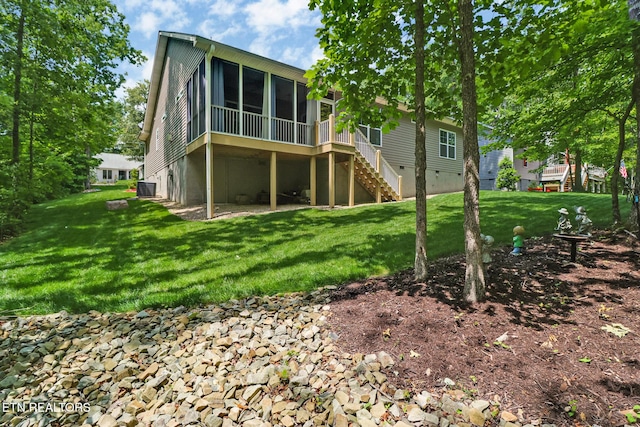 247 Thrushwood Dr, Fairfield Glade, TN 38558 - rear view of house with a sunroom, stairway, central AC, and a lawn