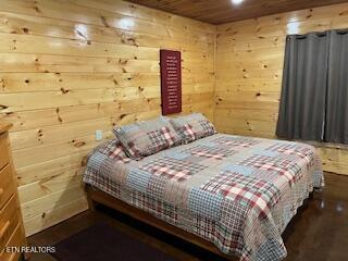 138 Matthews Rd, Oneida, TN 37841 - bedroom with wood ceiling and wood walls