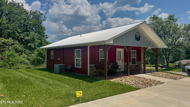 138 Matthews Rd, Oneida, TN 37841 - view of side of property featuring a yard, a porch, central air condition unit, metal roof, and stone siding