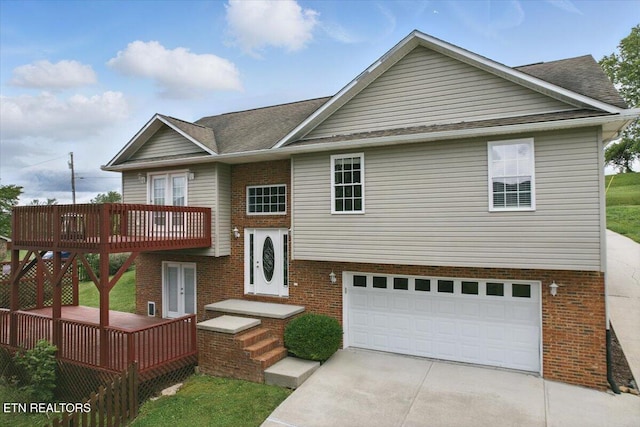 262 Cresent St, Harrogate, TN 37752 - split foyer home with driveway, brick siding, a garage, and a wooden deck