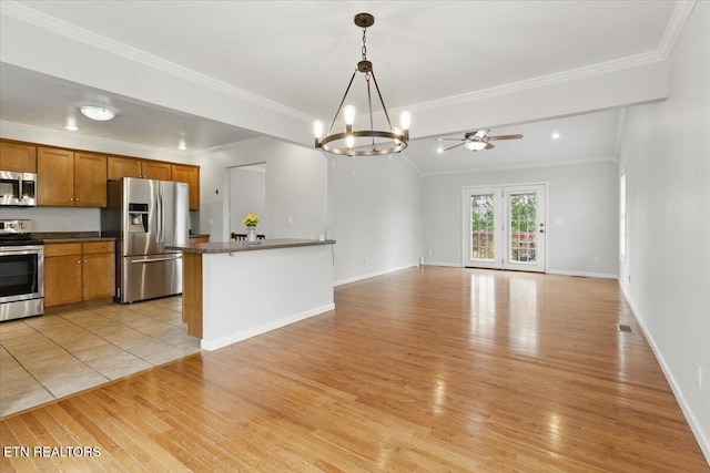 262 Cresent St, Harrogate, TN 37752 - kitchen featuring appliances with stainless steel finishes, dark countertops, a chandelier, crown molding, and brown cabinets