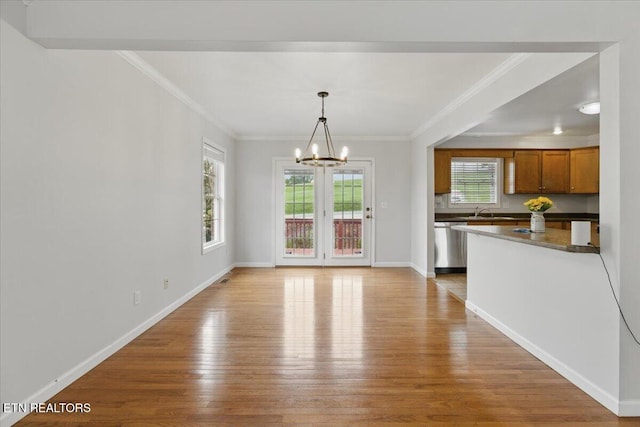 262 Cresent St, Harrogate, TN 37752 - unfurnished dining area featuring light wood-style floors, a chandelier, plenty of natural light, a sink, and ornamental molding
