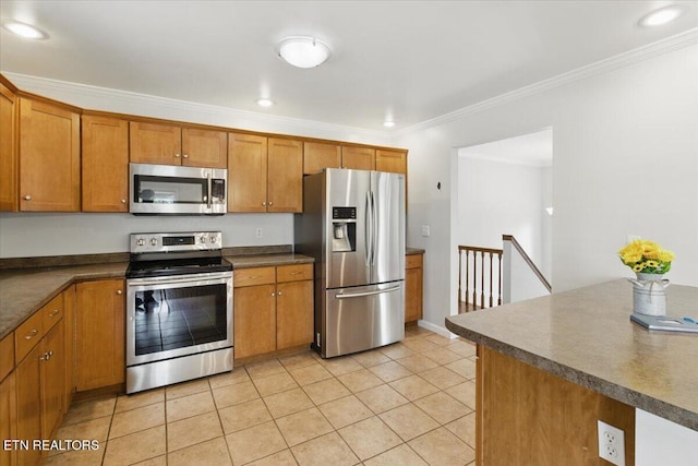 262 Cresent St, Harrogate, TN 37752 - kitchen featuring appliances with stainless steel finishes, brown cabinetry, crown molding, dark countertops, and light tile patterned floors