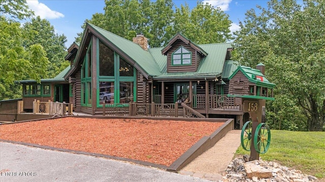 158 Dillon Rd, Baxter, TN 38544 - log-style house featuring a chimney, metal roof, covered porch, and log exterior