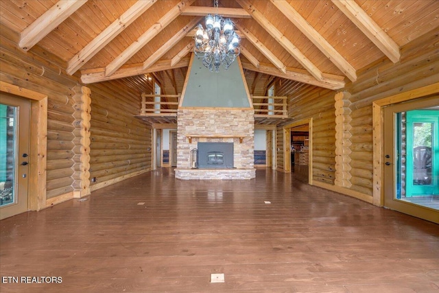 158 Dillon Rd, Baxter, TN 38544 - unfurnished living room featuring high vaulted ceiling, a chandelier, rustic walls, a fireplace, and hardwood / wood-style floors