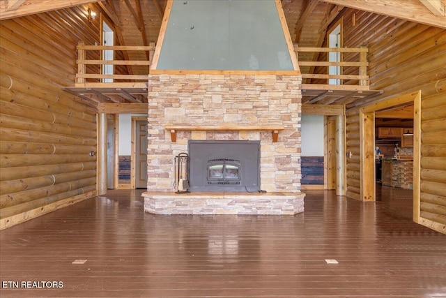 158 Dillon Rd, Baxter, TN 38544 - unfurnished living room with a towering ceiling, log walls, hardwood / wood-style flooring, a stone fireplace, and beam ceiling