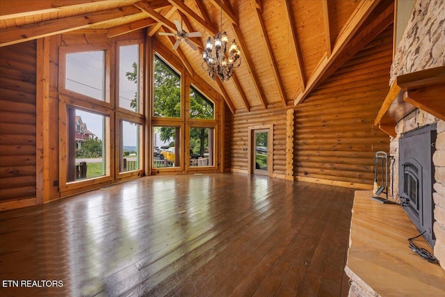 158 Dillon Rd, Baxter, TN 38544 - unfurnished living room with high vaulted ceiling, a fireplace, wood ceiling with exposed beams, log walls, and hardwood / wood-style floors