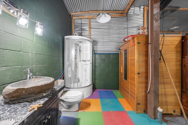158 Dillon Rd, Baxter, TN 38544 - bathroom with concrete block wall, toilet, and vanity