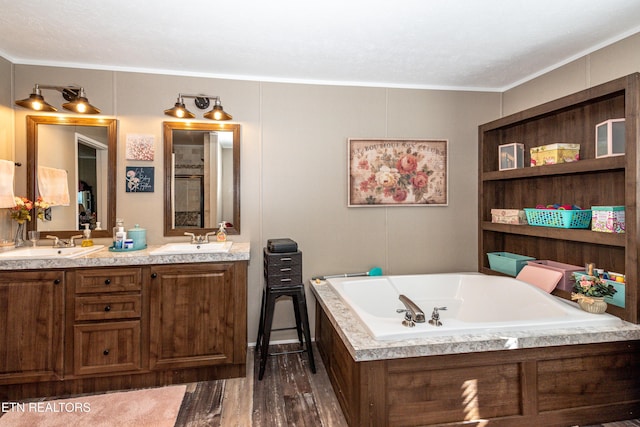 1193 Johnson Rd, Seymour, TN 37865 - bathroom with double vanity, a garden tub, wood finished floors, and crown molding